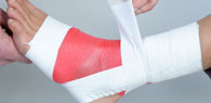 close up of a physio taping a patients ankle